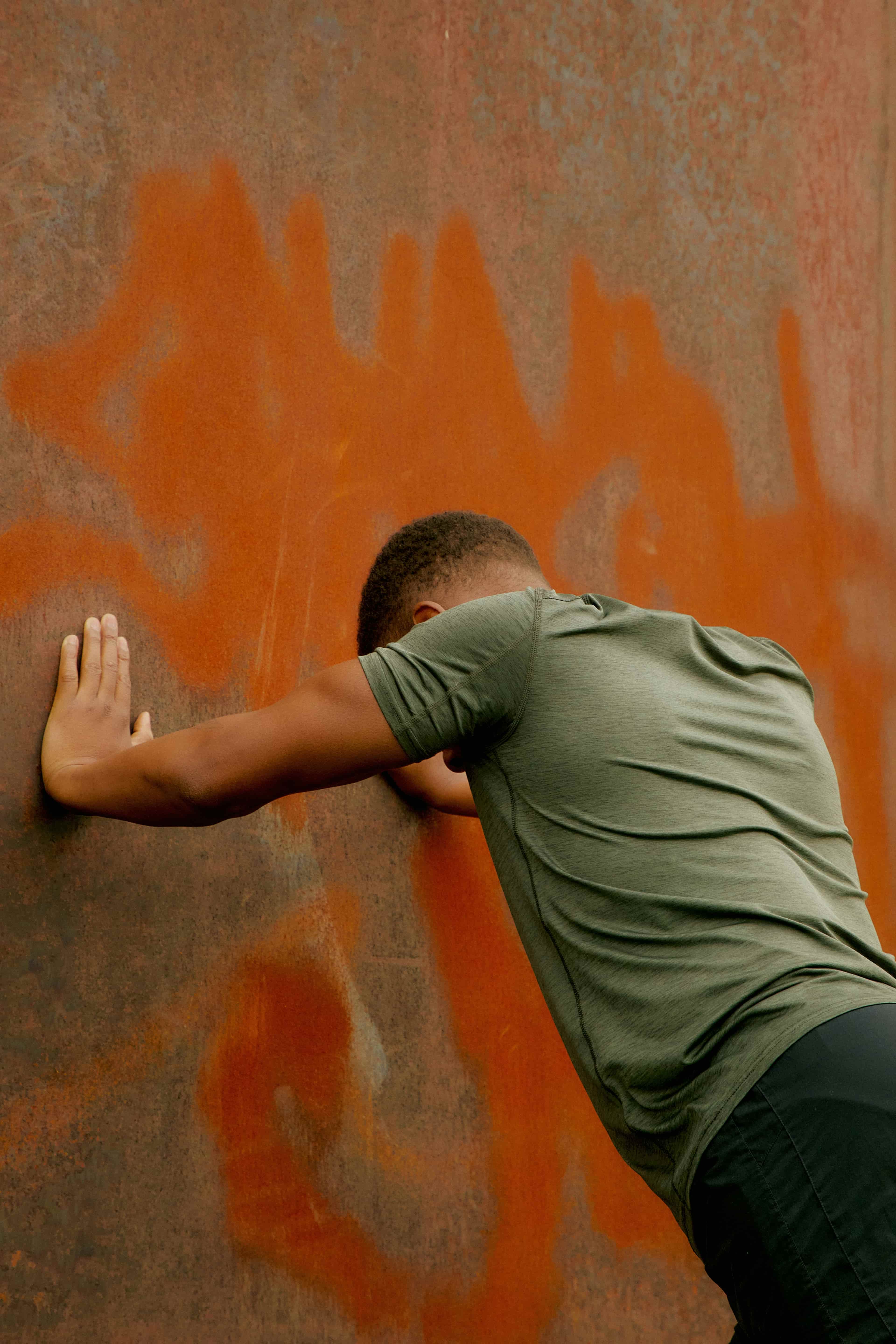 A man leaning against a wall